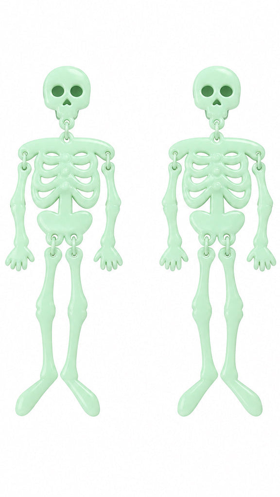 Pair of glow in the dark skeleton decorations on white background