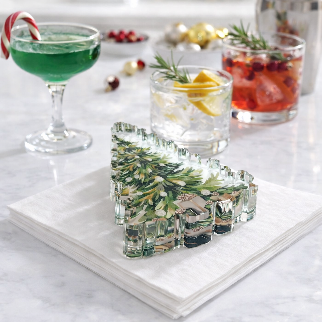 Clear glass bear-shaped ice mold with Christmas tree design on a marble surface with cocktails in the background.
