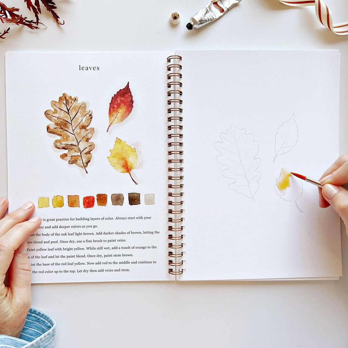Painting fall leaves in the autumn watercolor workbook