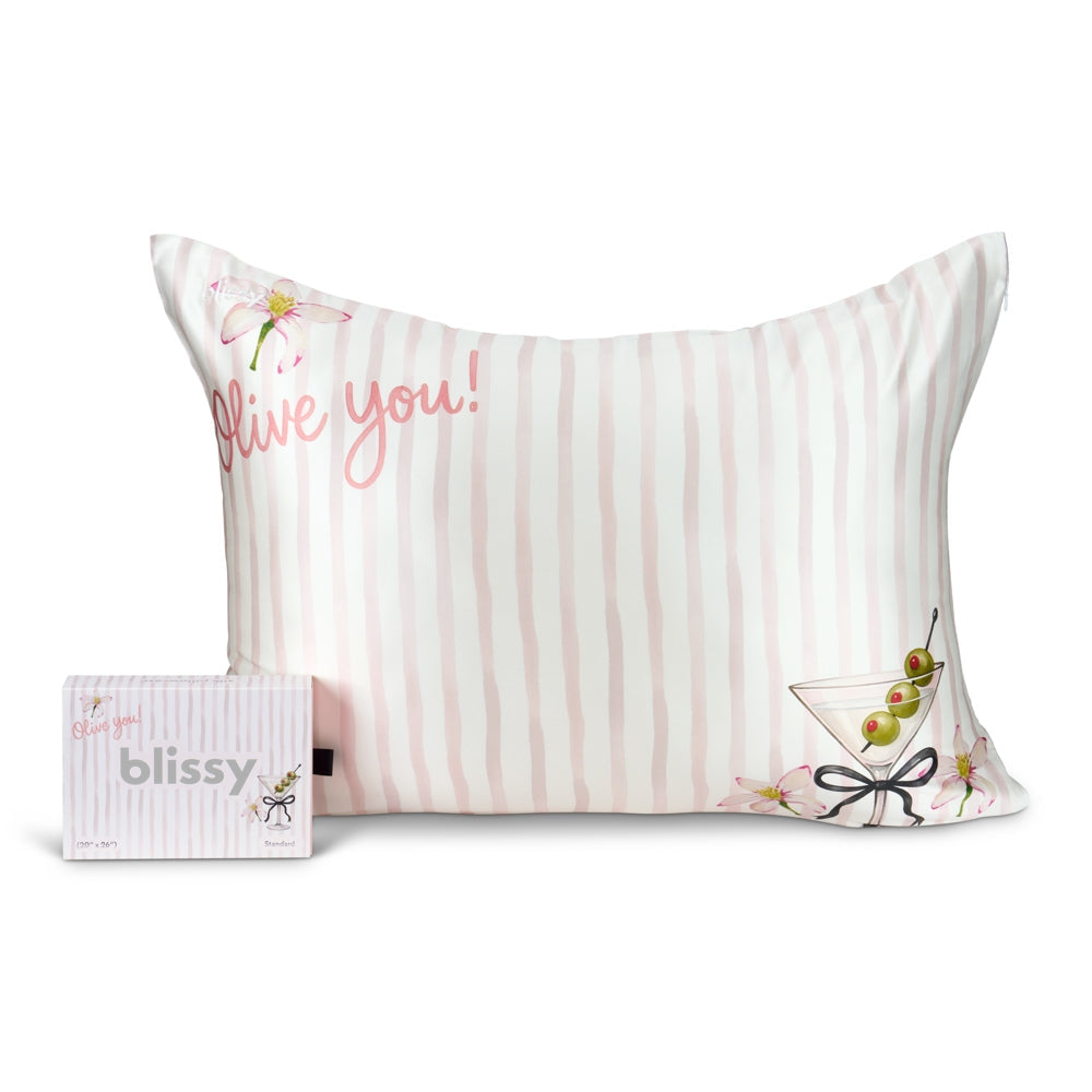 Striped pillow with 'I love you!' text and a martini glass design, featuring the brand 'blissy'.