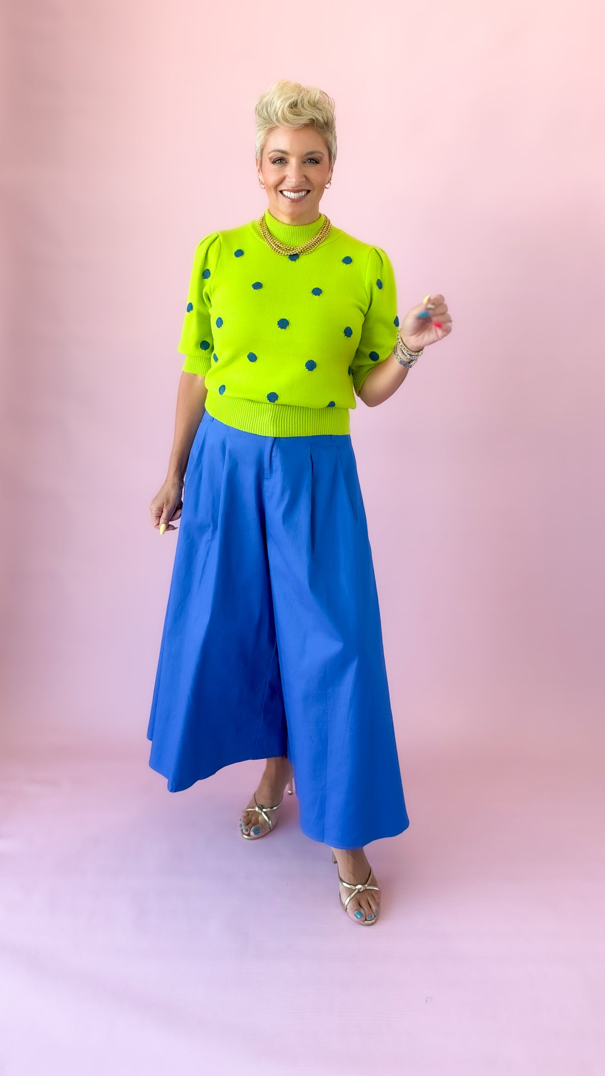 Cobalt blue culotte pants with lime green sweater and heels