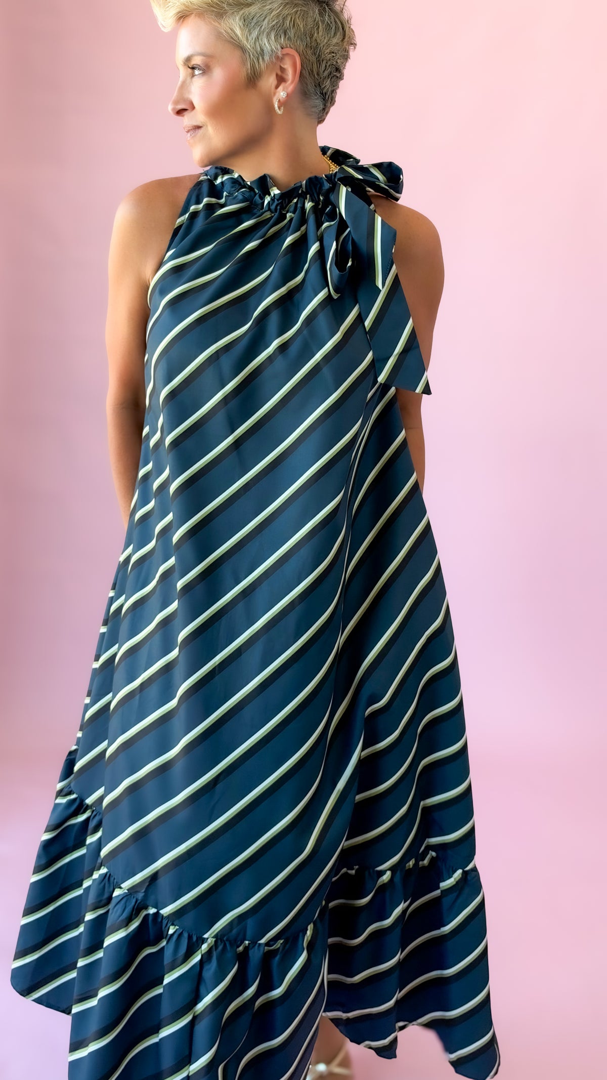 Back angle of teal and white striped tie neck midi dress