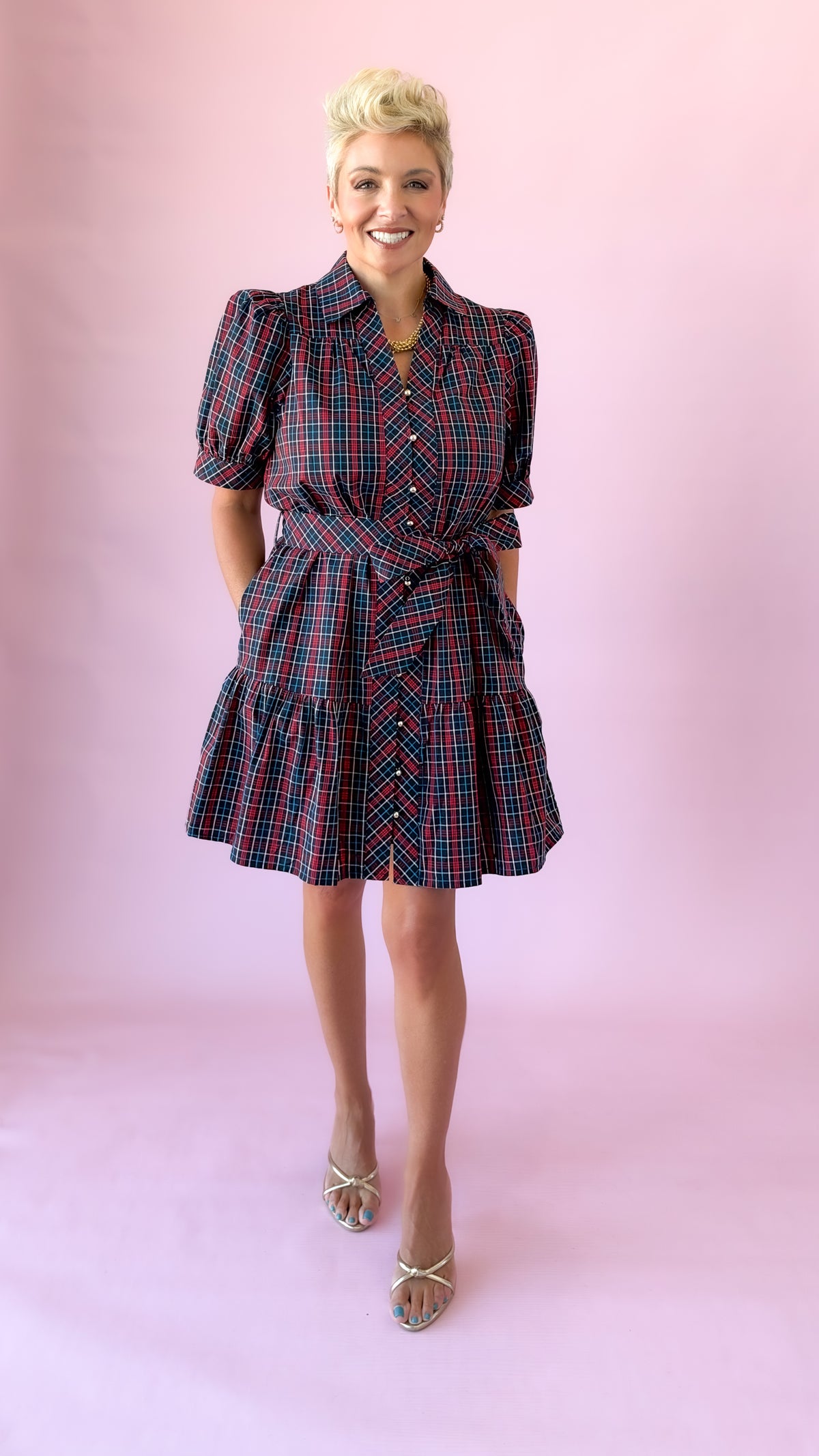 Front view of navy plaid Angelica mini dress styled with metallic heels