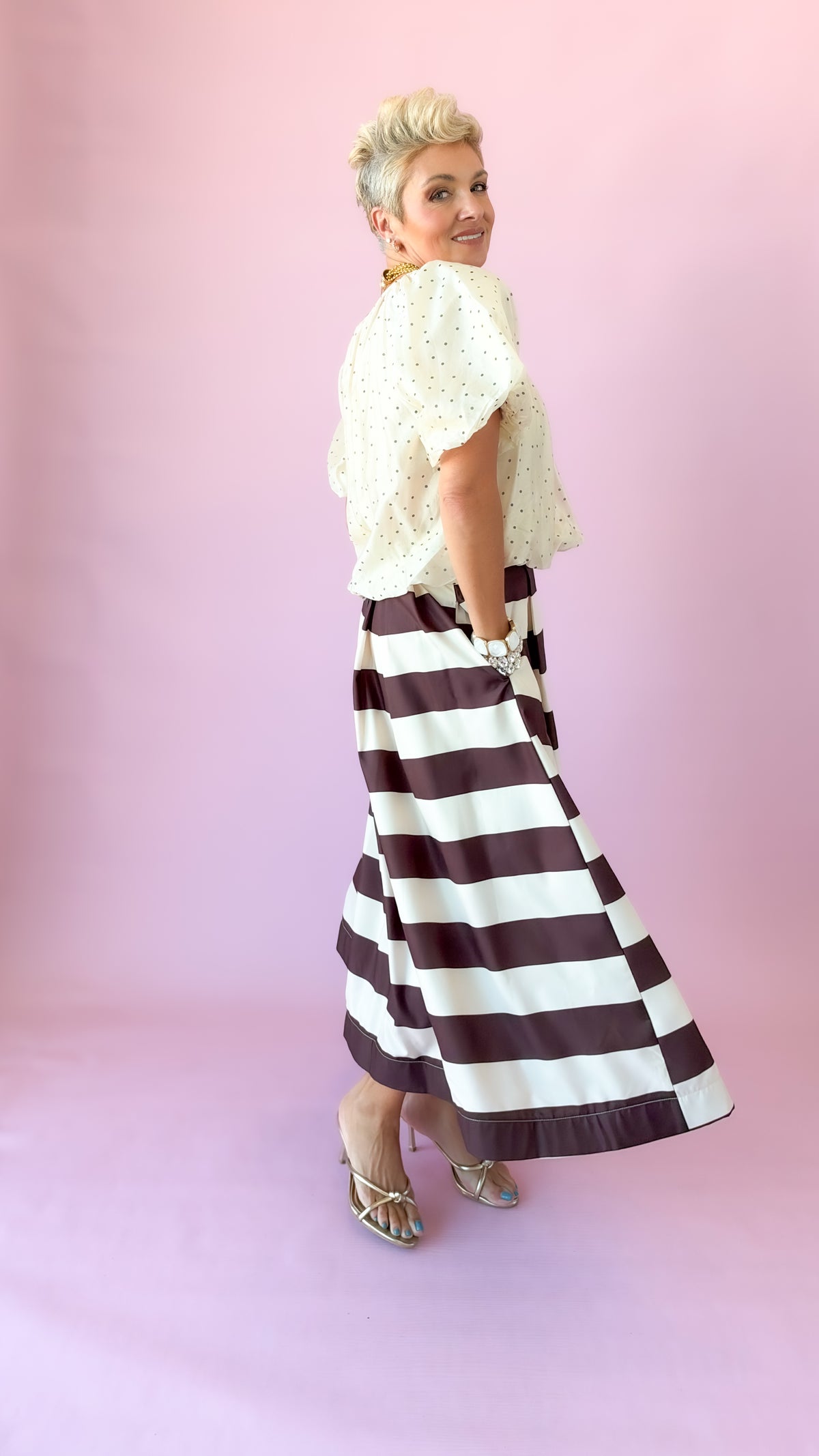 Side profile of ivory flutter puff sleeve top in motion