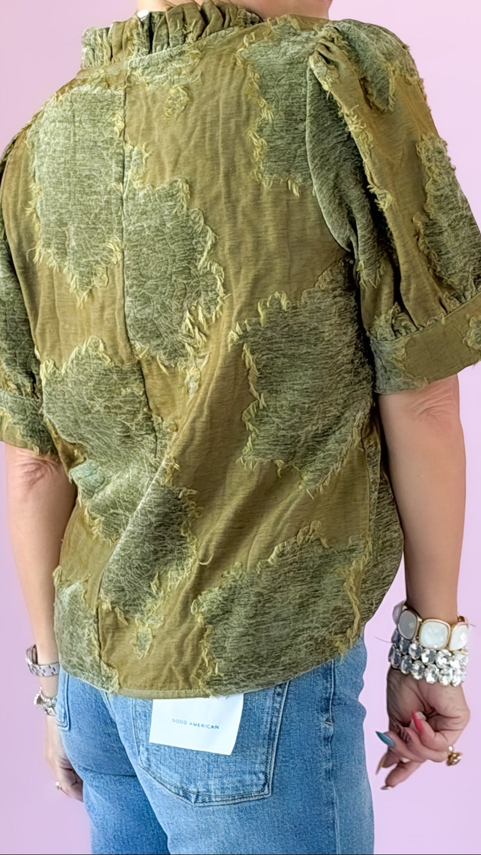 Back view of olive luxe patchwork top showing textured fabric and puff sleeves