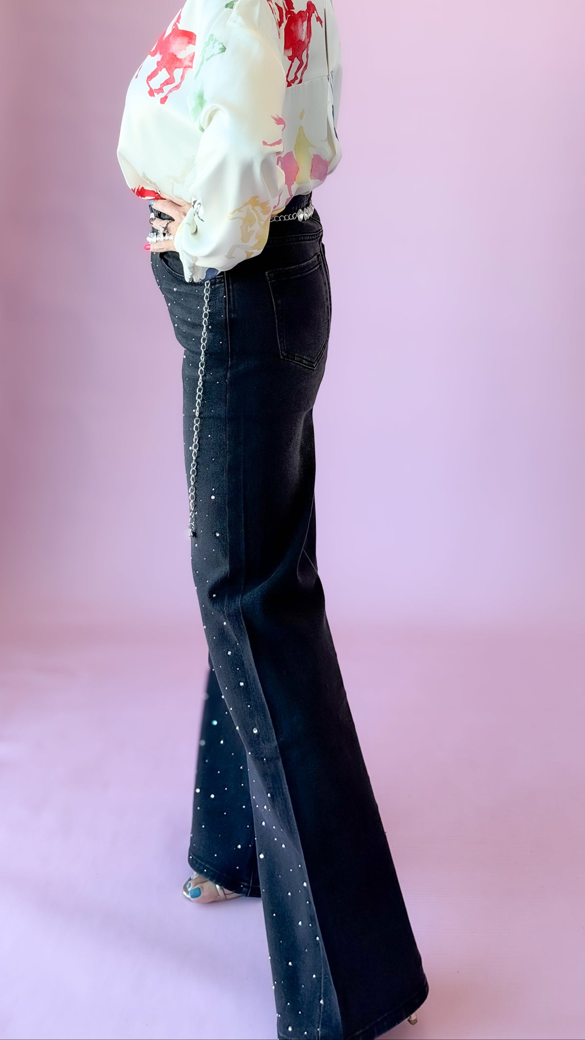 Side view of black studded flare jeans
