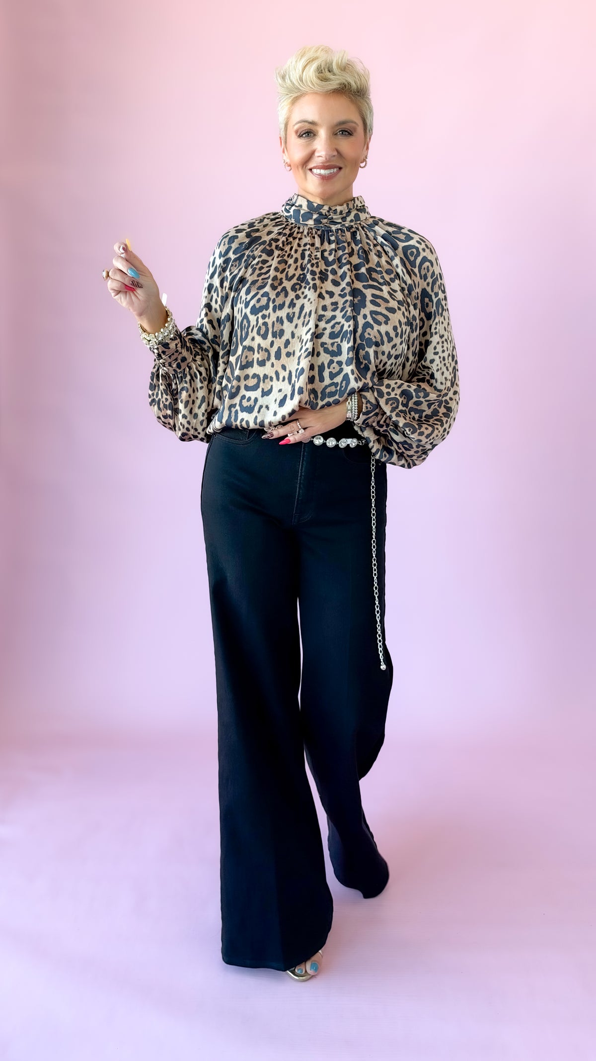 Full-length view of Jessie leopard front top styled with black wide-leg pants