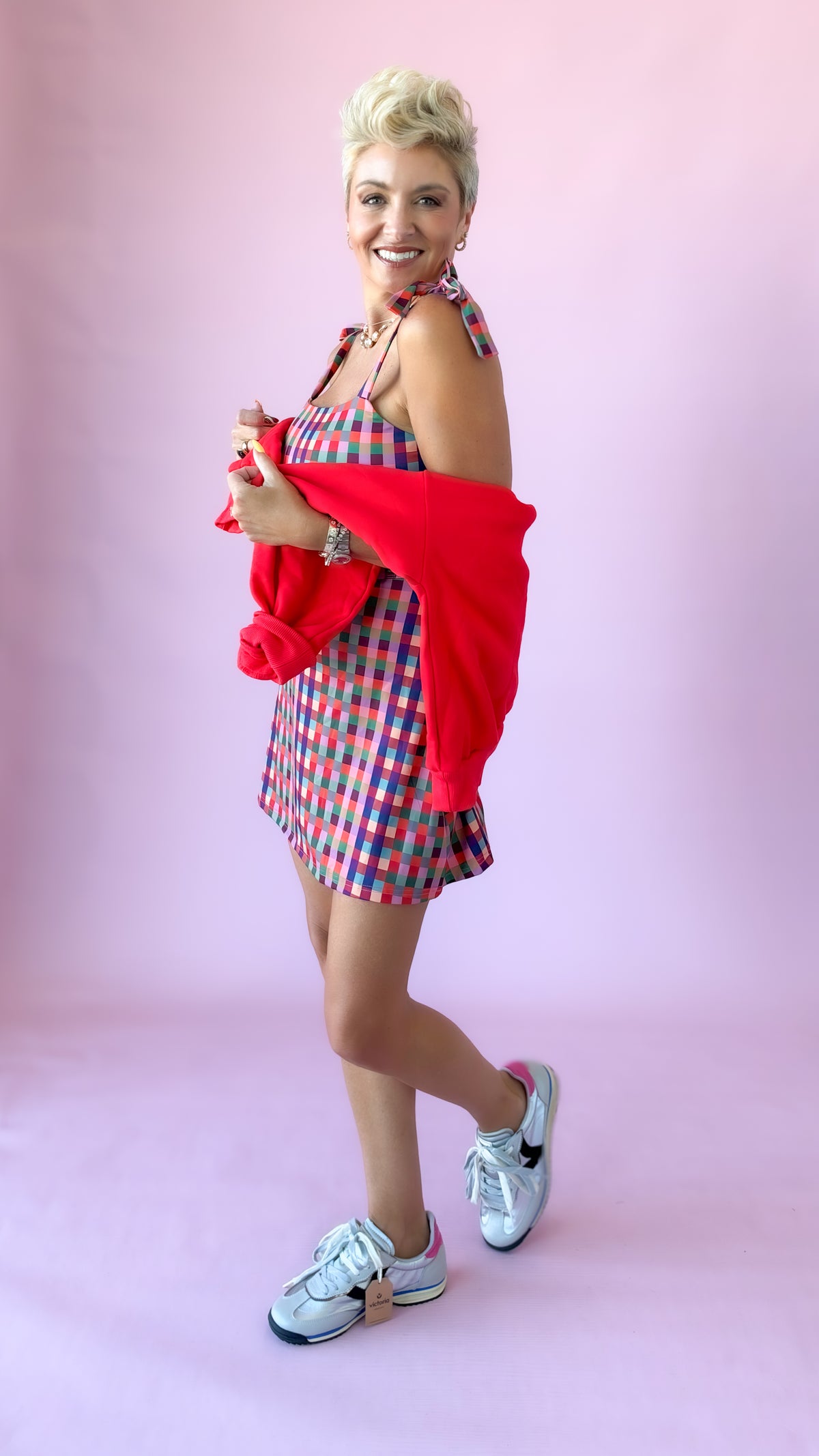 Gingham mini athletic dress with tie shoulder straps and white sneakers
