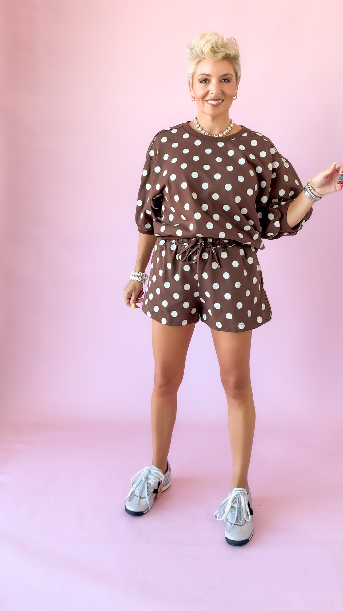 Full-length view of brown polka dot lounge top set with sneakers