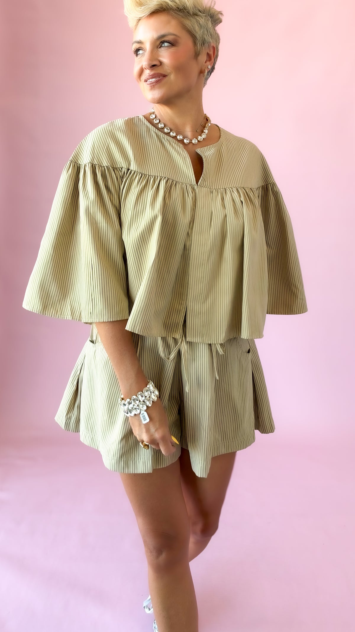Beige striped swing cape top with flowing sleeves and matching shorts