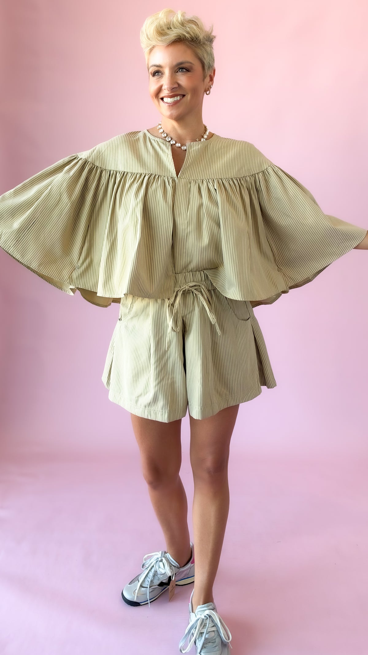 Beige striped elastic waist shorts set with swing cape top and sneakers
