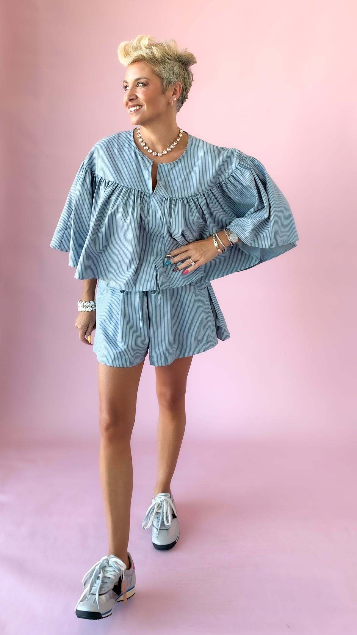 Light blue striped elastic waist shorts set with swing cape top and sneakers