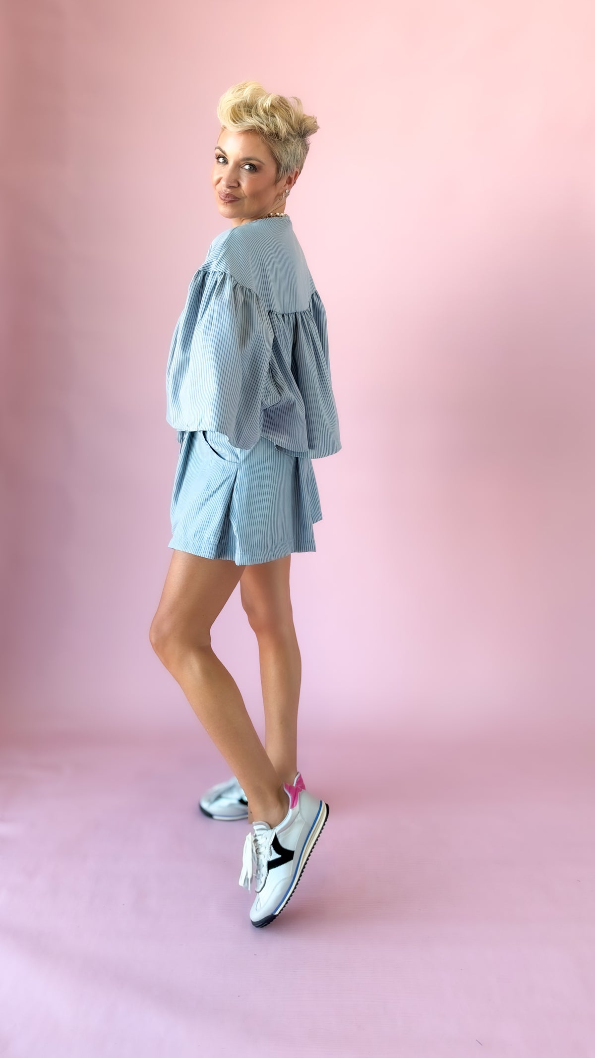Side view of light blue striped swing cape top and shorts