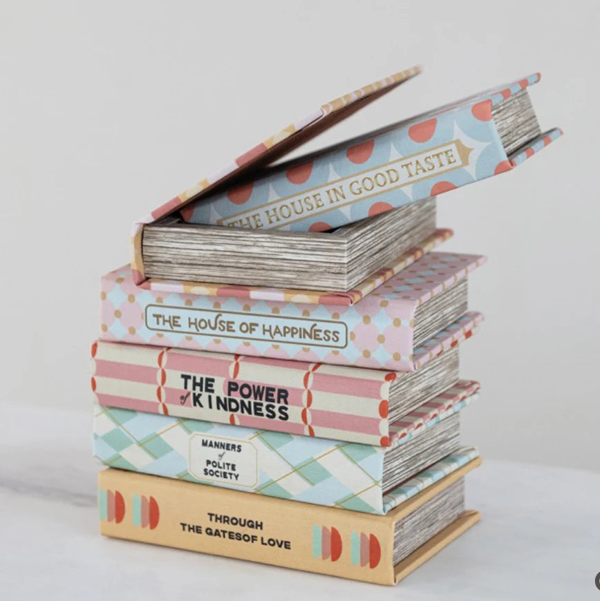 Stack of books with decorative covers on a white background