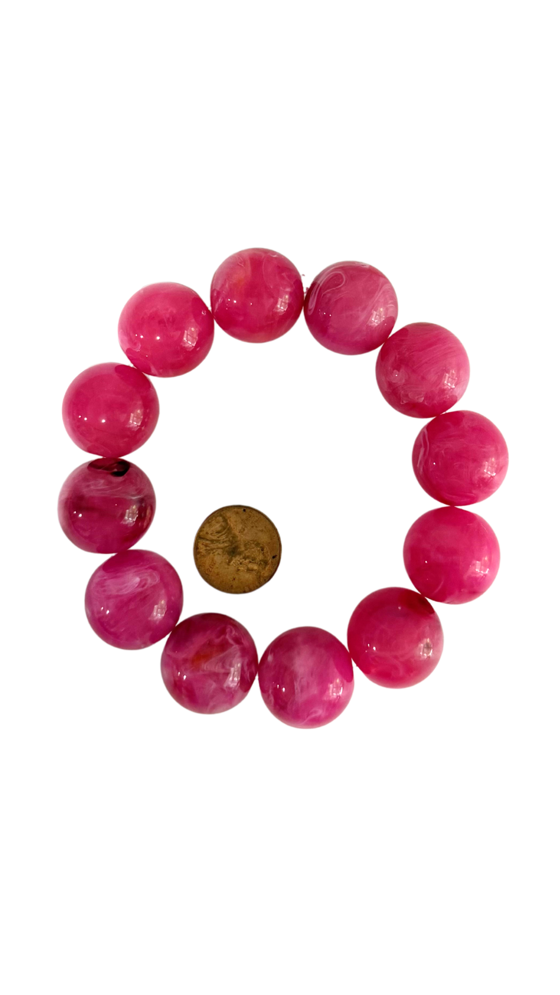 Bracelet with pink beads and a brown bead on a white background
