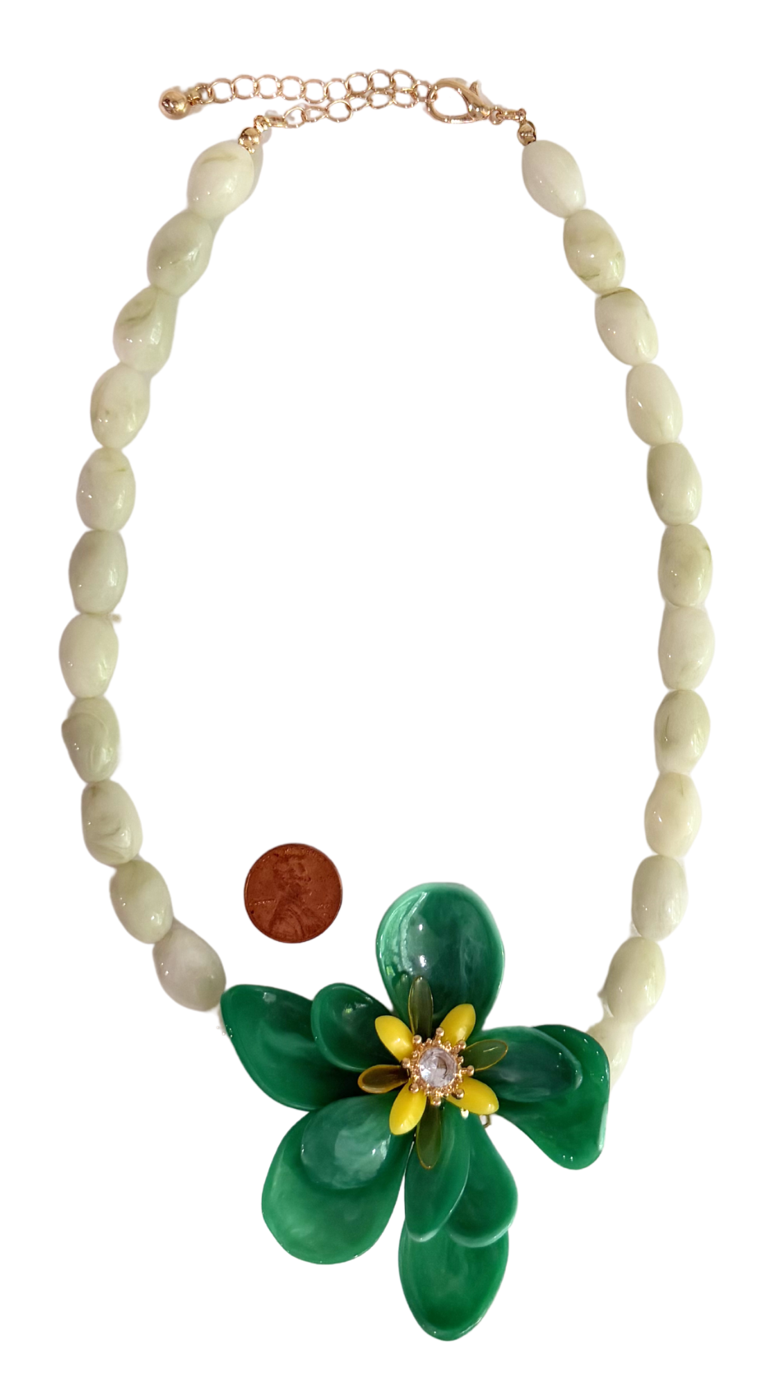 Necklace with green flower pendant and brown bead on a white background