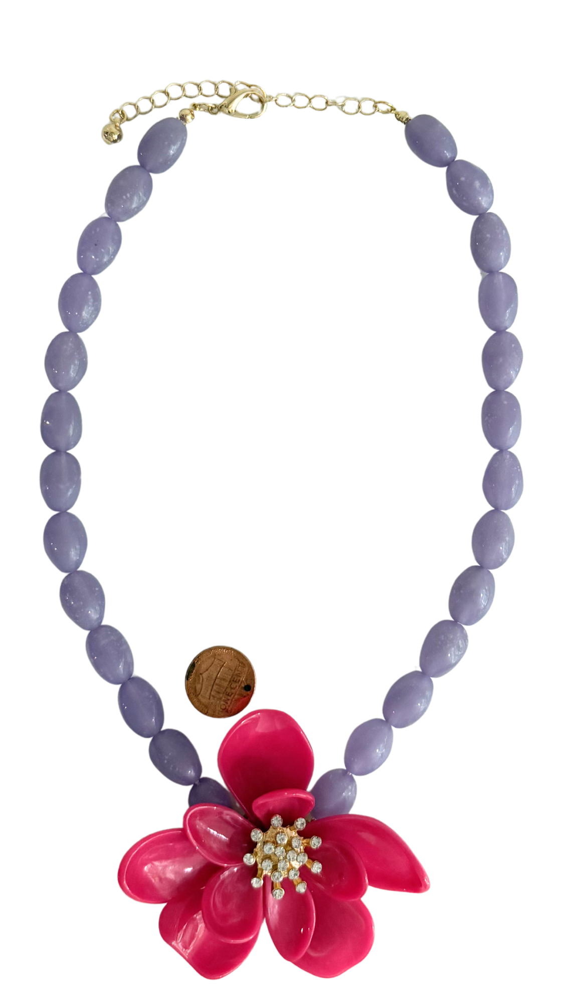 Necklace with purple beads and a pink flower pendant on a white background