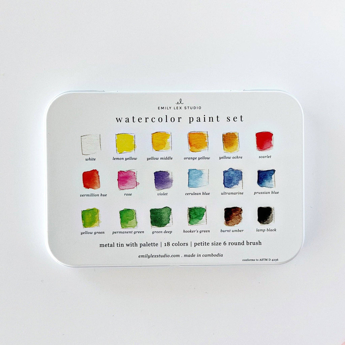 Watercolor paint set tin open showing 18 color pans