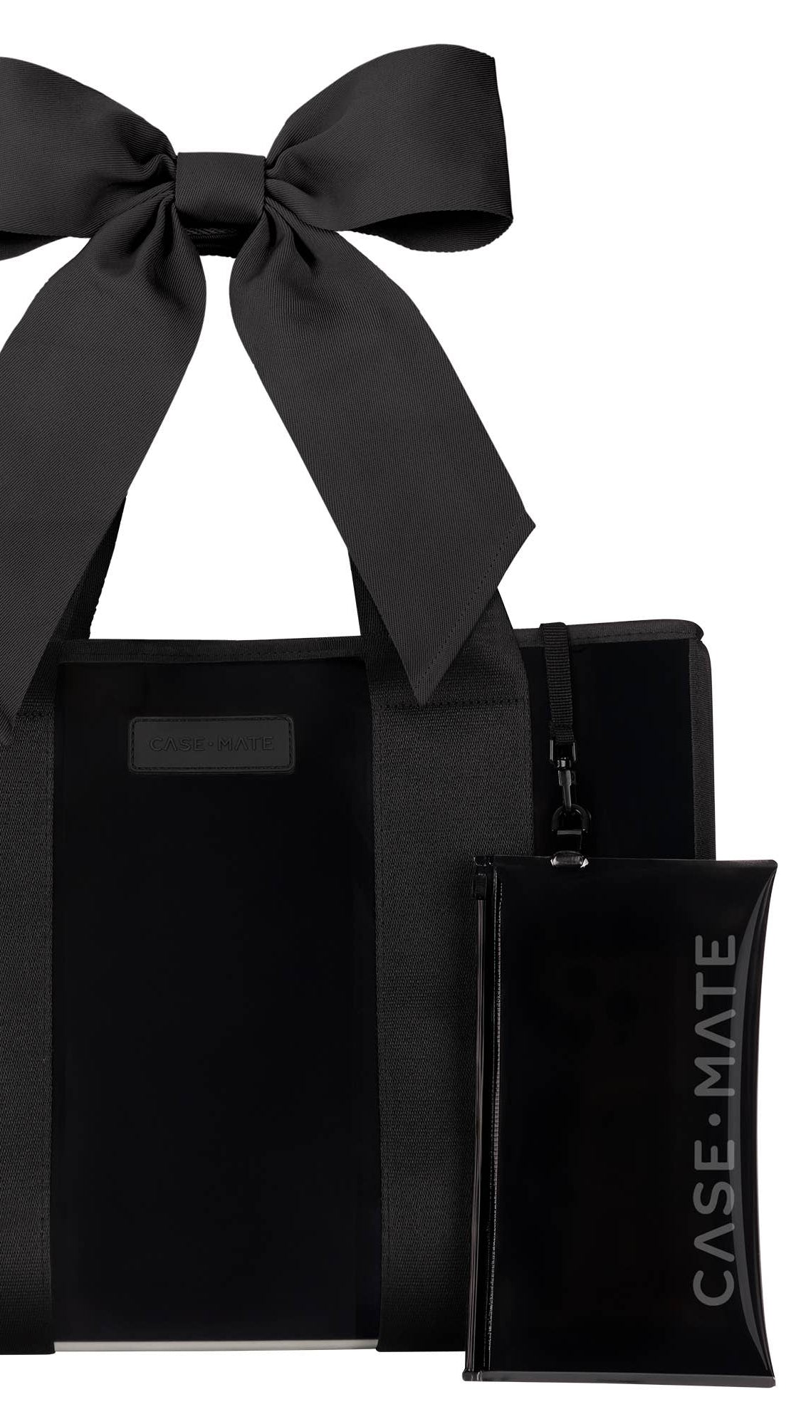 Black tote bag with a large black bow and a matching pouch on a white background