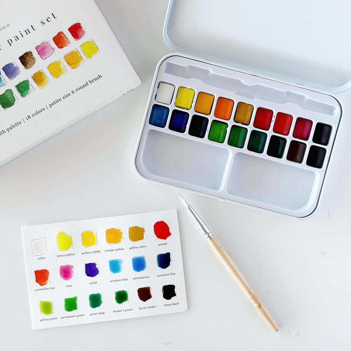 Watercolor paint set with color swatch card and brush
