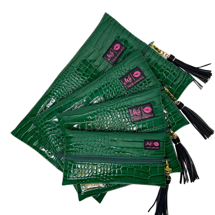 Stack of green clutch bags with visible brand logo on a white background