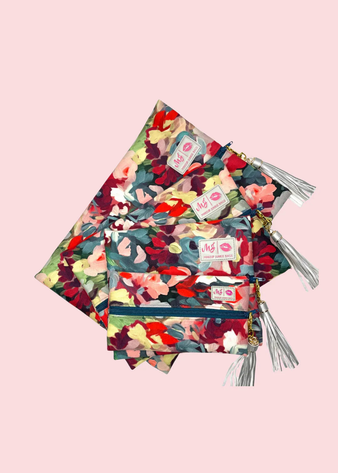 Stack of floral-patterned books with tassels on a pink background