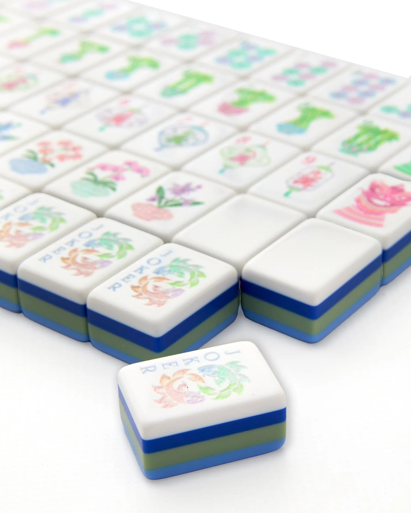 Set of colorful game tiles with floral designs on a white background