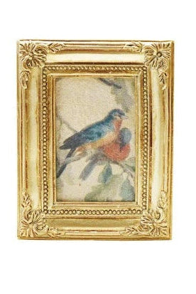 Collection of gold-framed pictures with various scenes on a white background