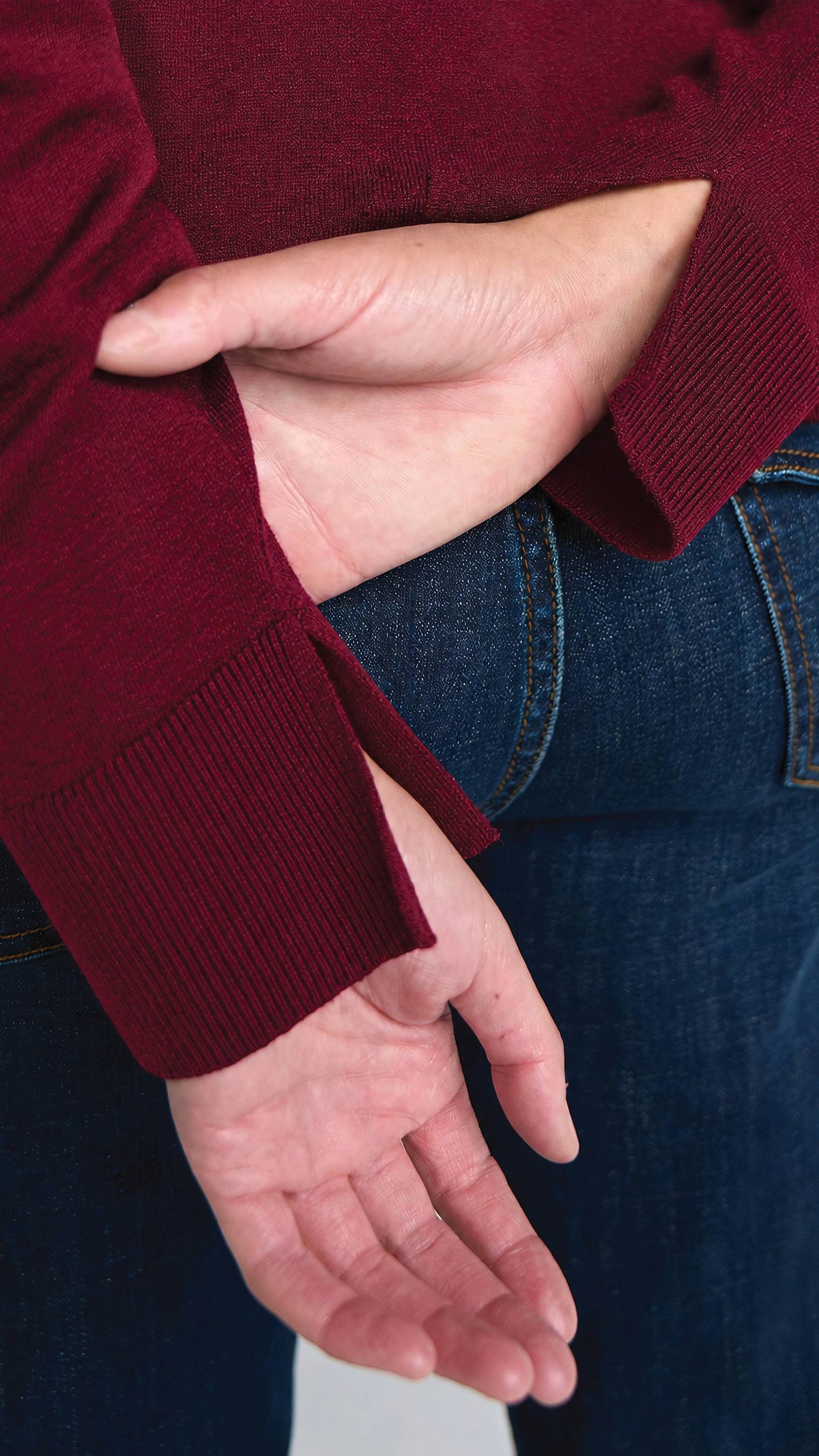 Close-up of slit sleeve cuff on merlot mixed media sweater