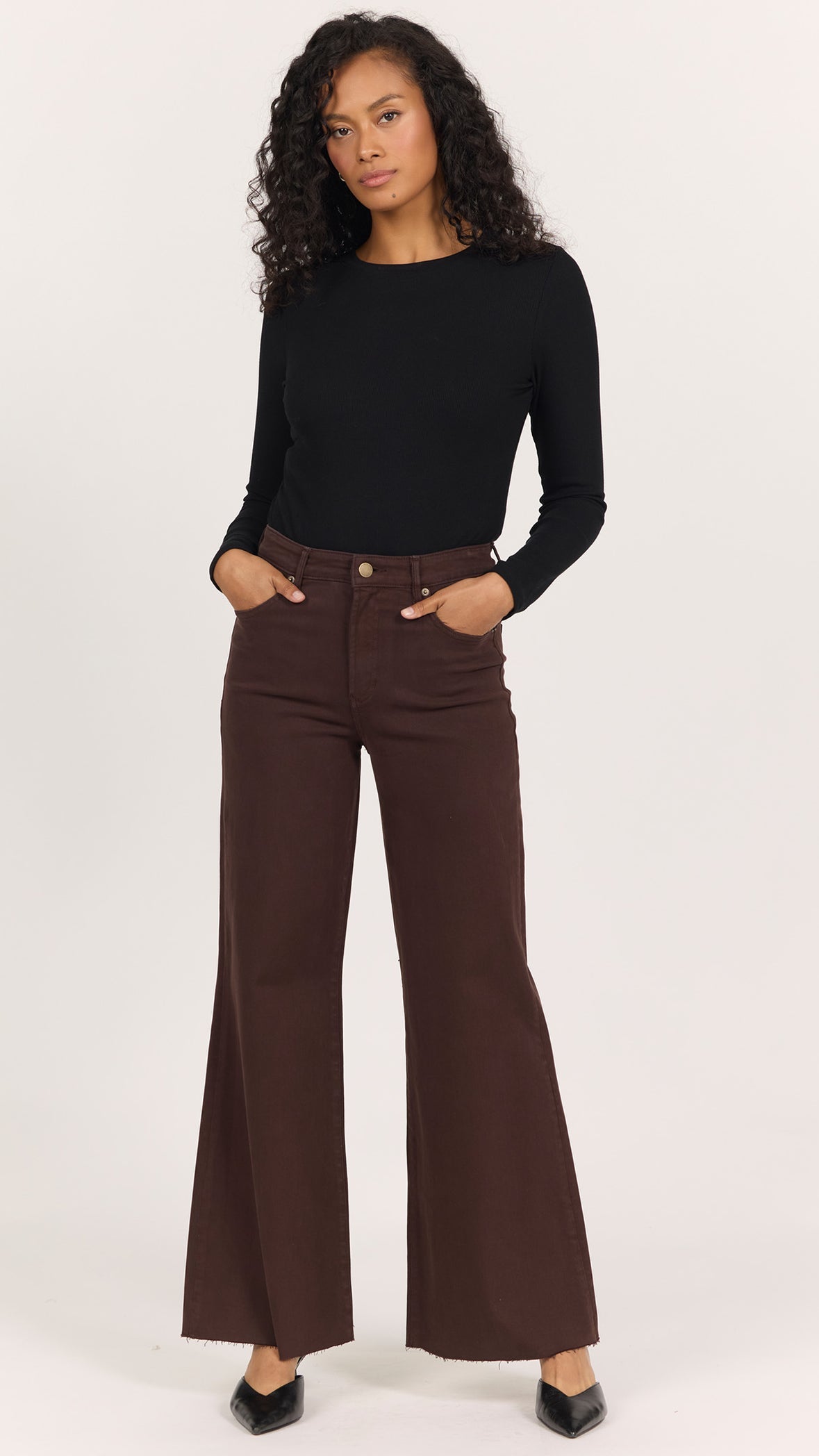 Full-length front view of Dear John Fiona wide leg jeans in dark oak brown worn with a black fitted long sleeve and black pointed heels