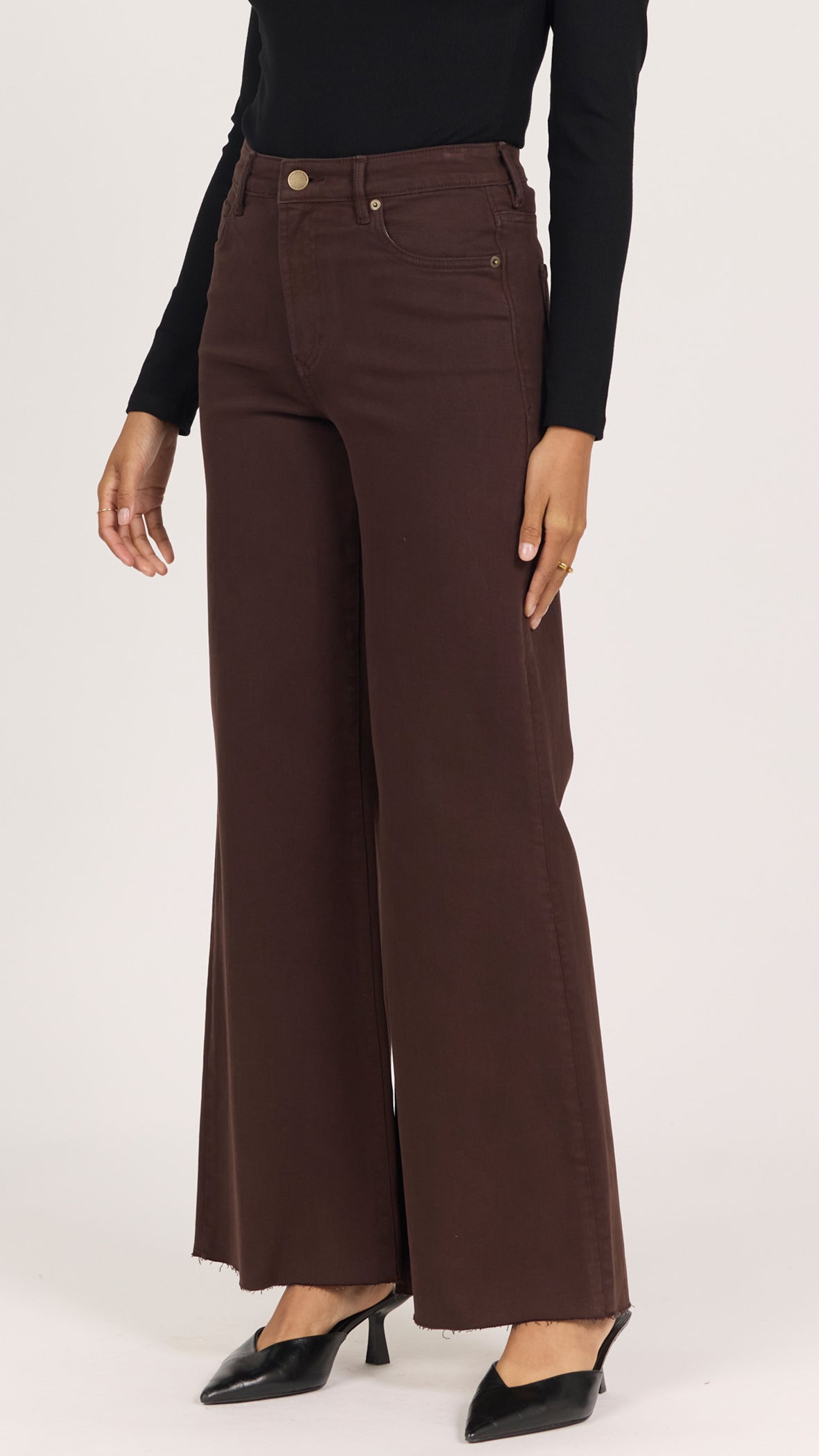Three-quarter side view of dark oak Fiona wide leg jeans with black pointed heels