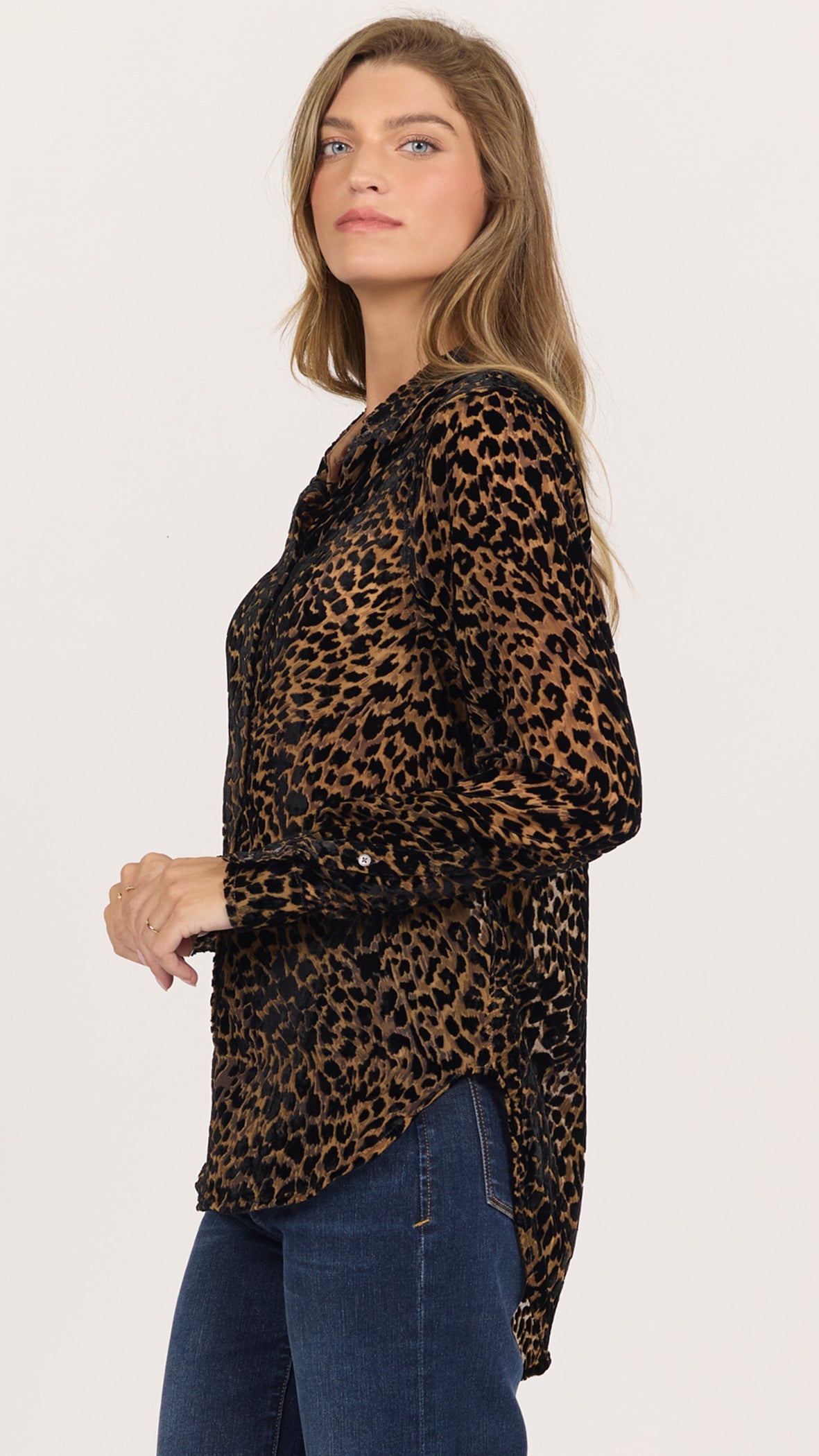 Three-quarter side view of black and caramel leopard Lolita shirt showing the long sleeve and curved shirttail hem