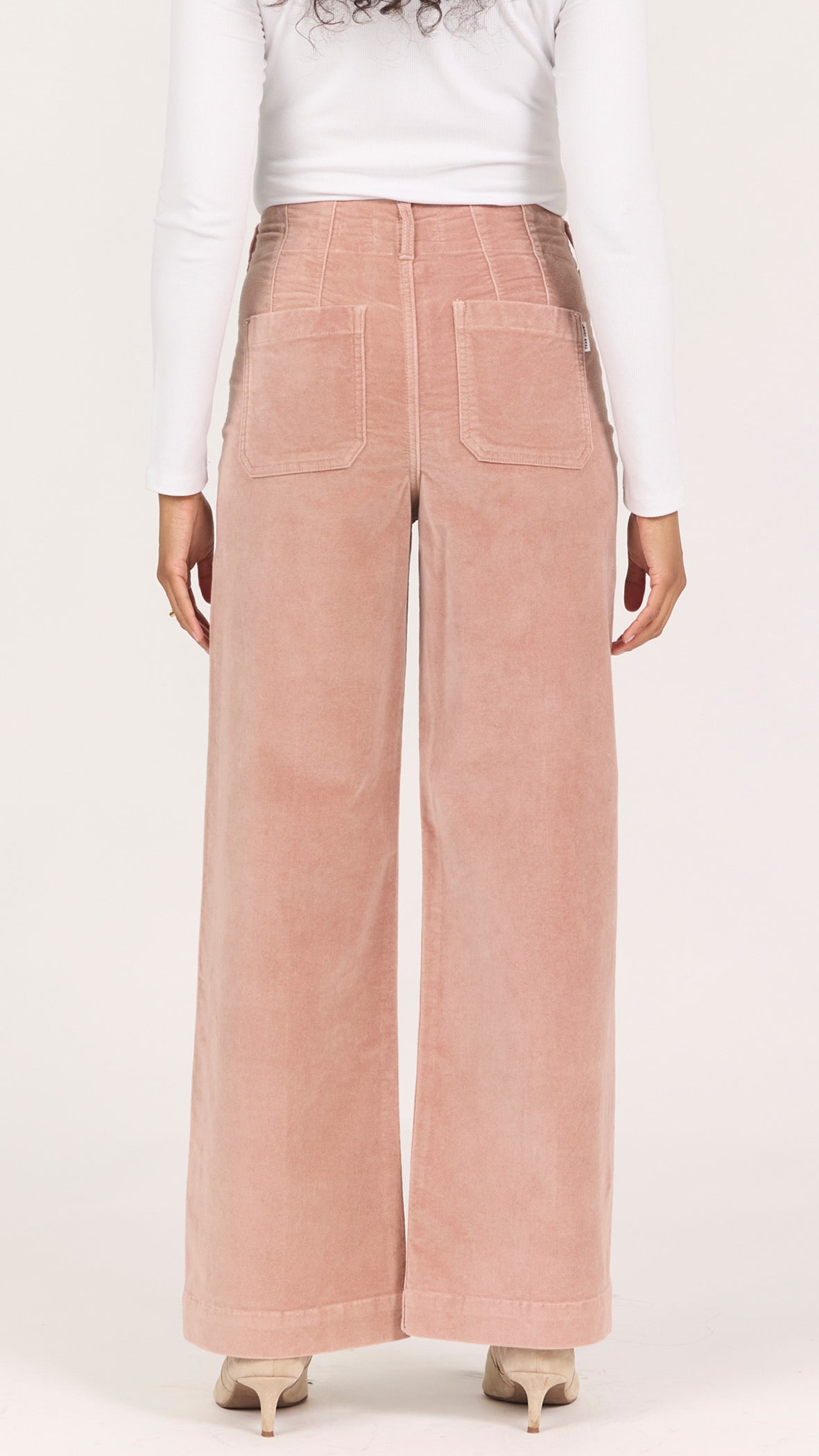 Back view of soft latte corduroy Audrey pants showing the back patch pockets and full-length wide leg