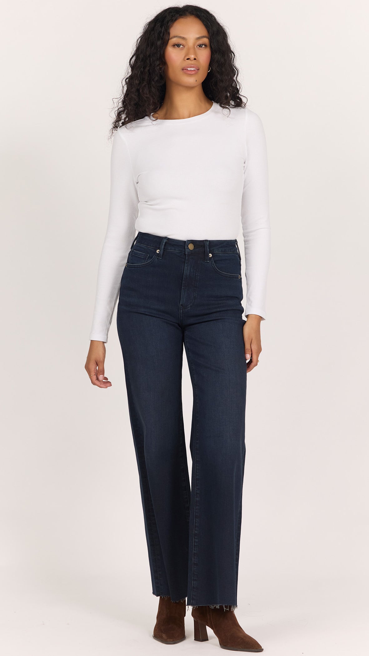 Full-length front view of Dear John Fiona wide leg jeans in inkwell worn with a fitted white long sleeve and brown suede ankle boots
