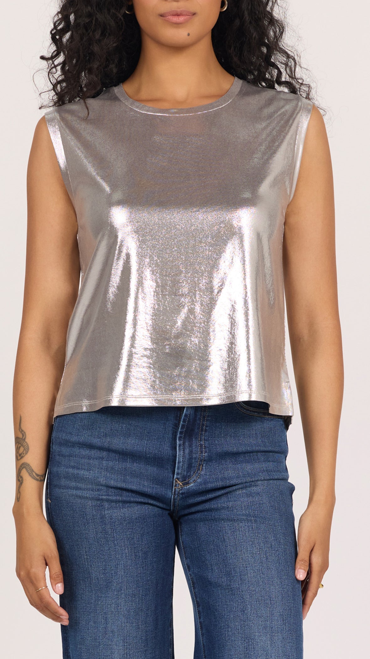 Front view of silver lurex Charli sleeveless muscle tee with a round neckline, worn with dark jeans