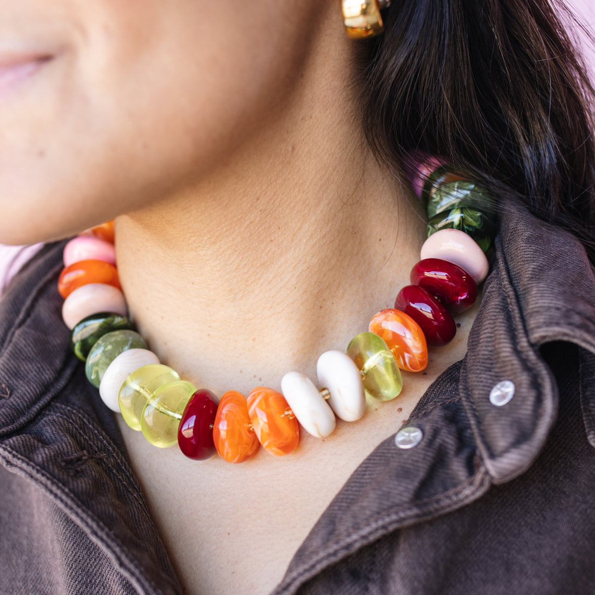 Model wearing The Icon Necklace in orange and neon