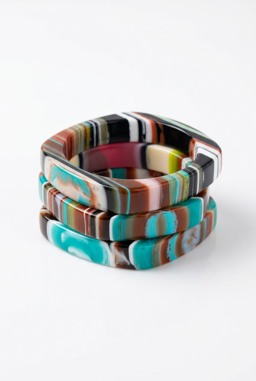 Square multicolor resin bangle bracelets in teal, brown and cream marbled stripes, stacked view.