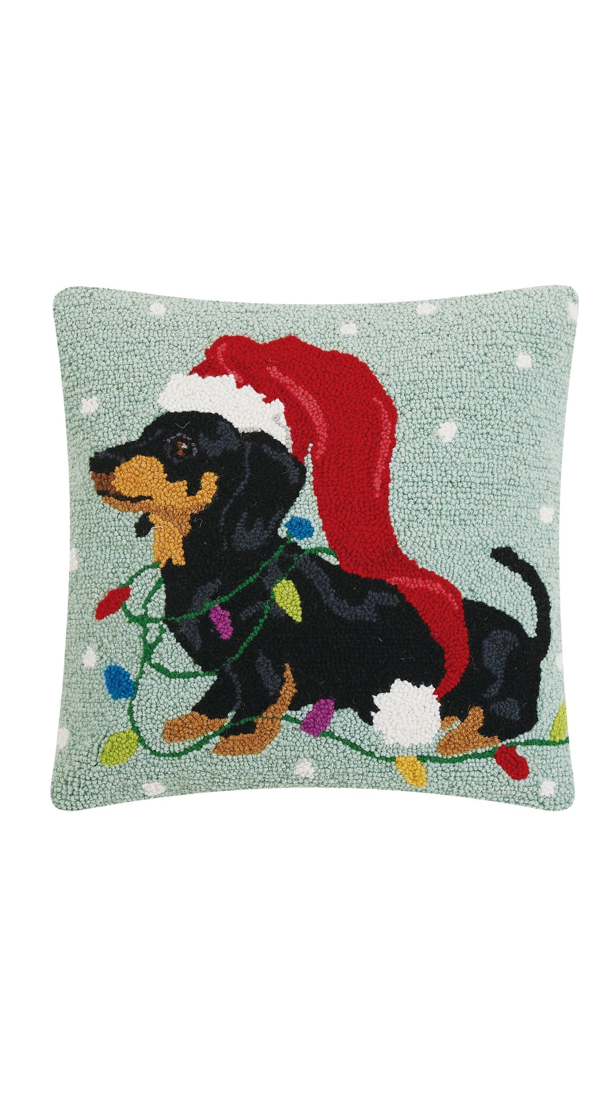 Hooked wool pillow of a dachshund in a long Christmas hat, full view on white