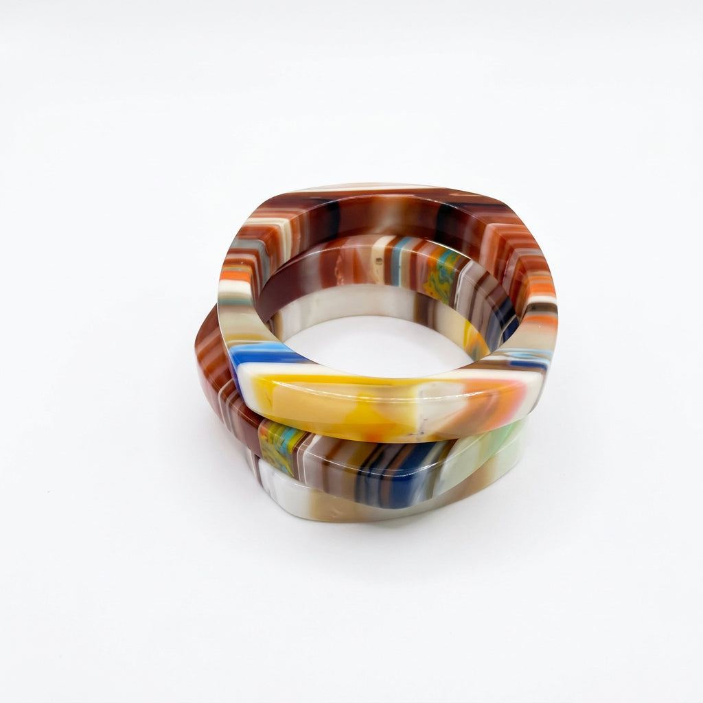 Square multicolor resin bangle bracelets in brown, cream, yellow and blue stripes, stacked view.