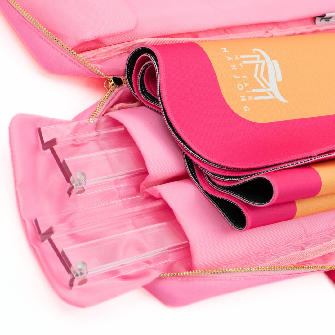 Pink makeup organizer with a mirror and brushes on a white background