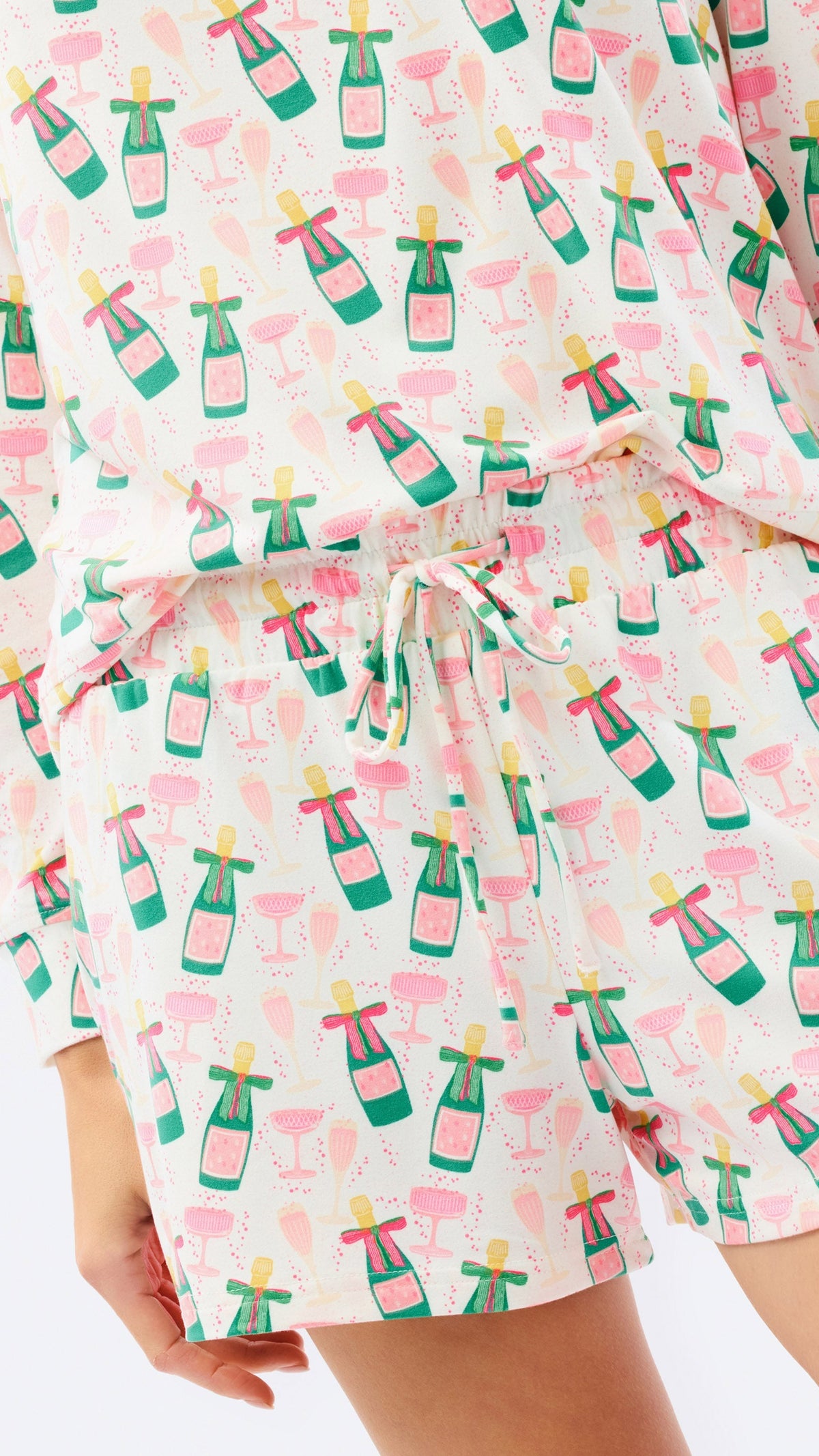 Close-up of the champagne bottle and flute print on the Annie pajama set with white drawstring