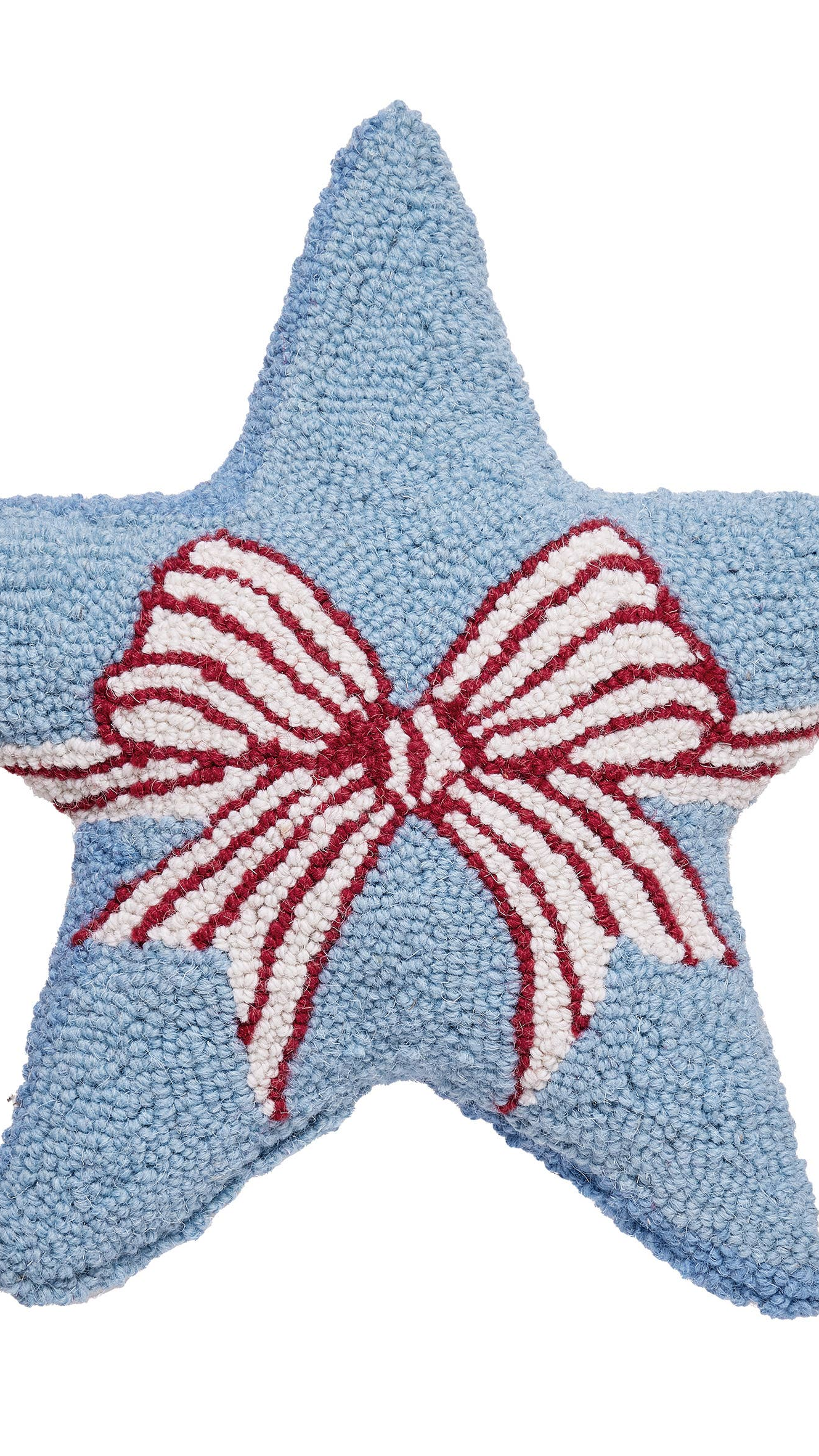 Blue star-shaped pillow with a red and white bow on a white background