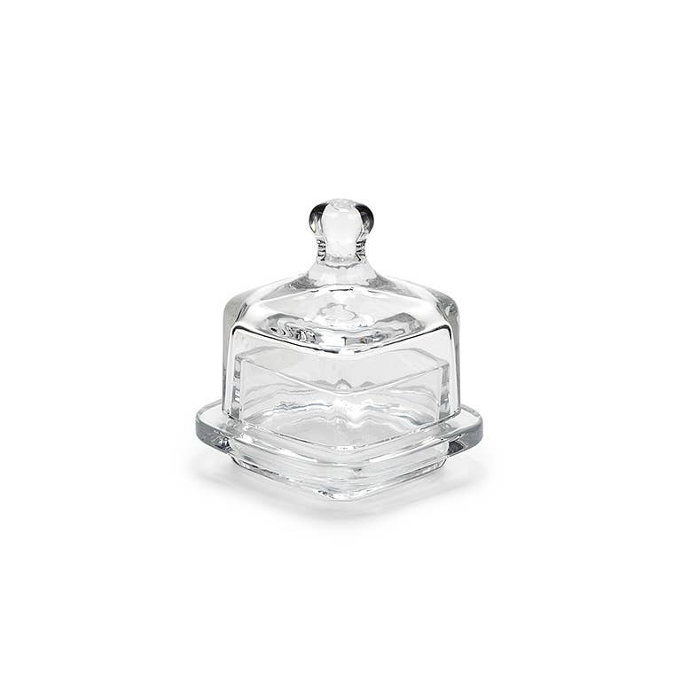 Clear glass butter dish with lid on a white background