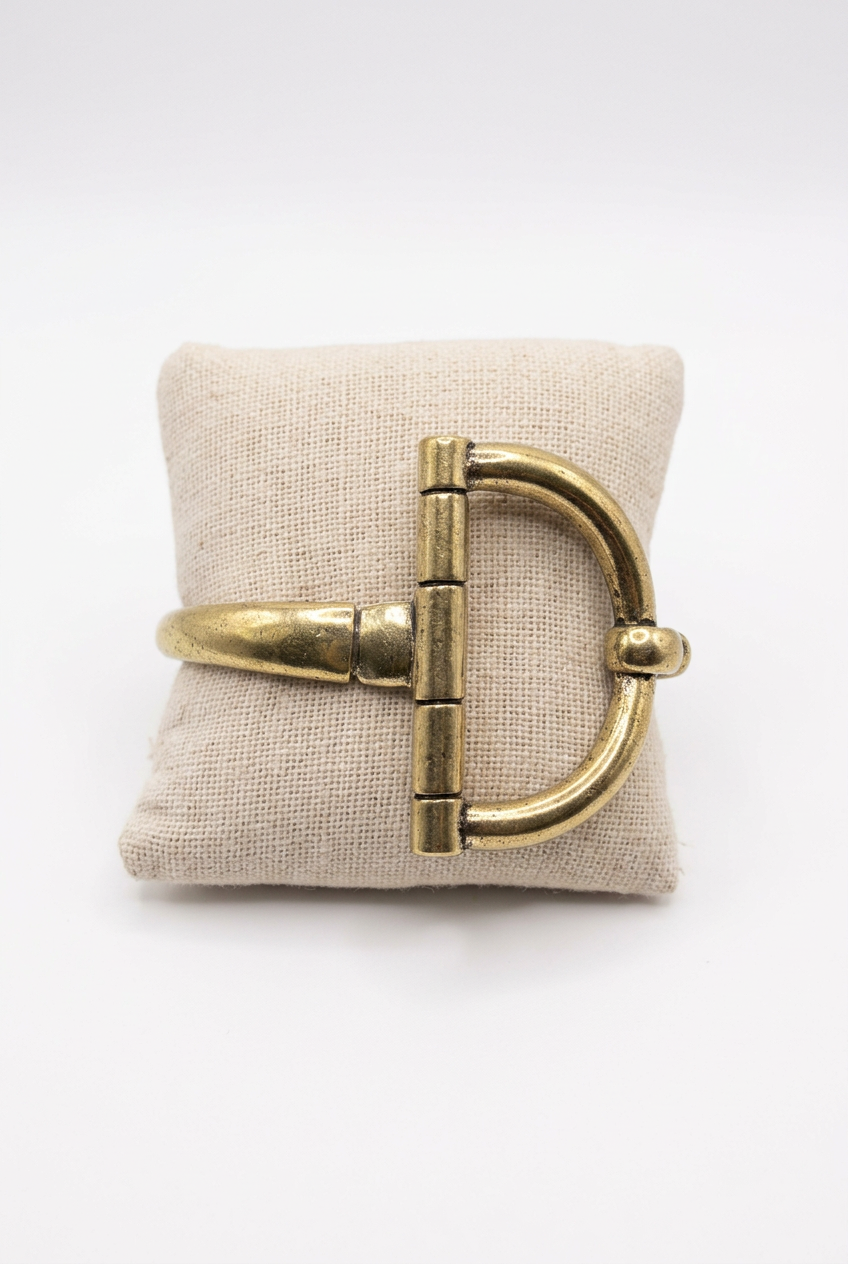 Accessories to Go Large Stretch Horse Bit Bracelet in gold tone on a linen pillow