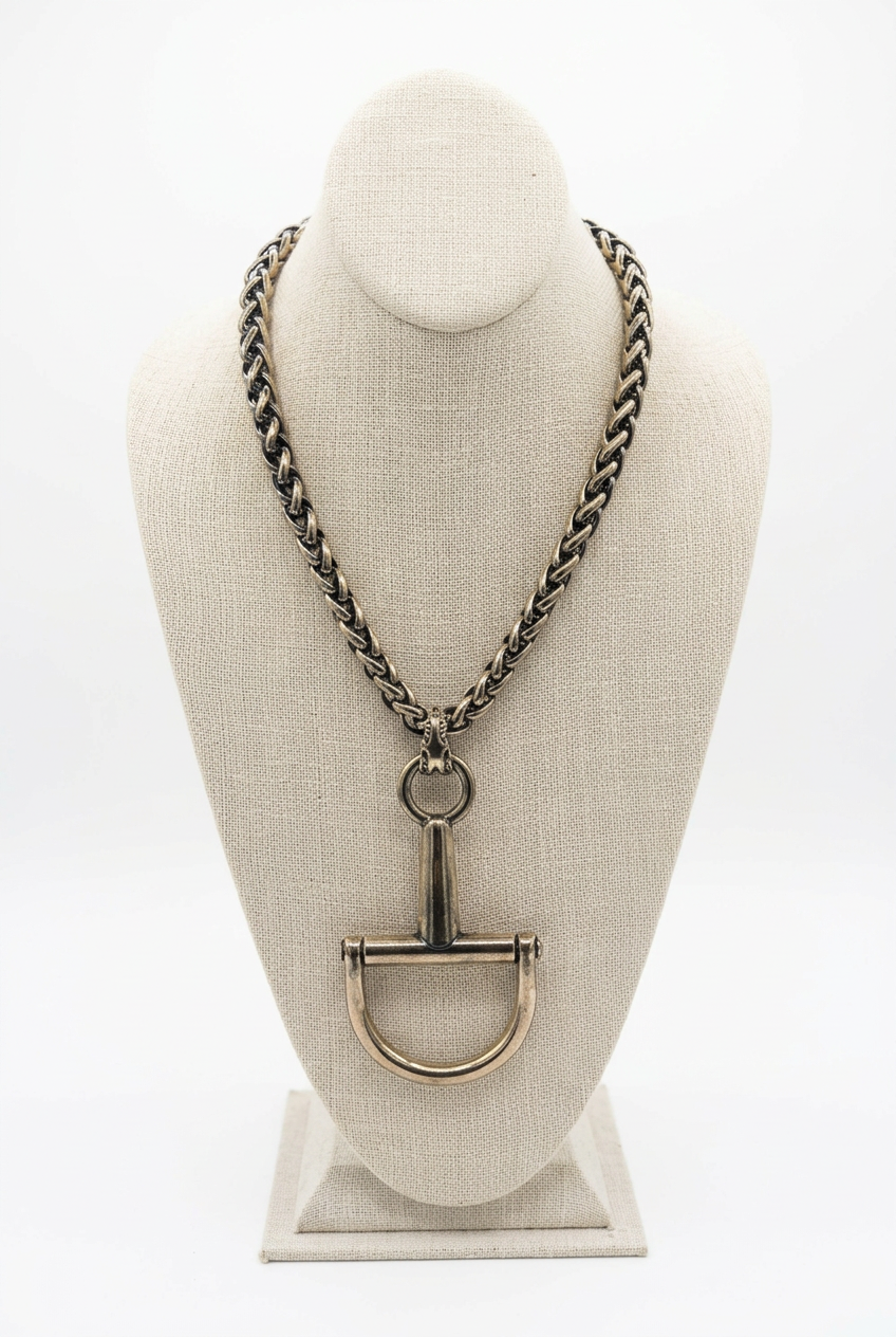 Accessories to Go Large Horse Bit Pendant Necklace in antique gold tone with chunky chain on a linen bust
