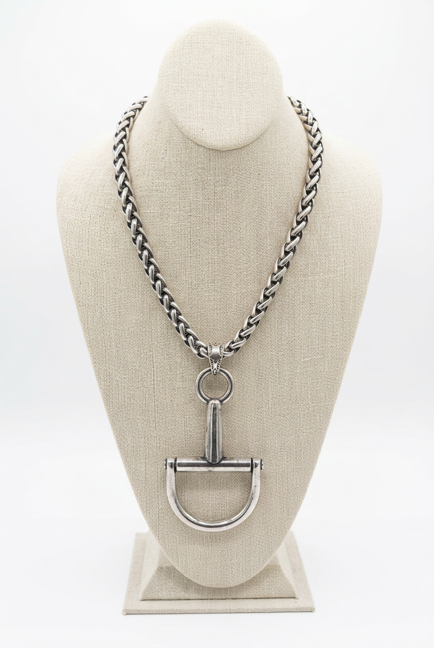Accessories to Go Large Horse Bit Pendant Necklace in silver tone with chunky chain on a linen bust