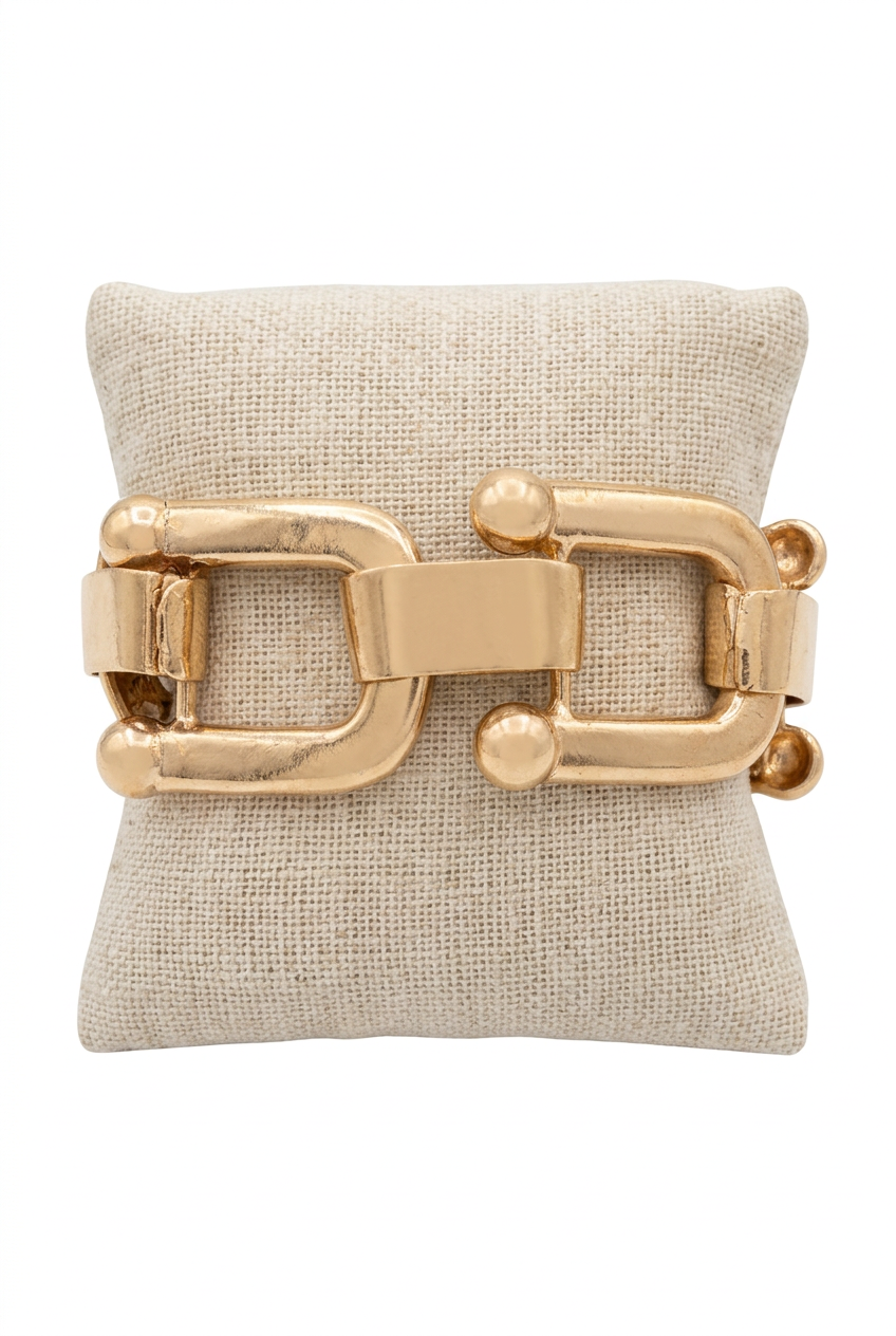 Accessories to Go U-Link Bracelet in gold tone with oversized open links on a linen pillow