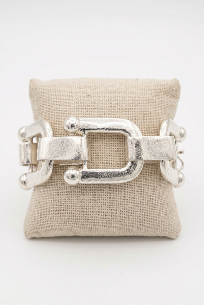 Accessories to Go U-Link Bracelet in silver tone with oversized open links on a linen pillow