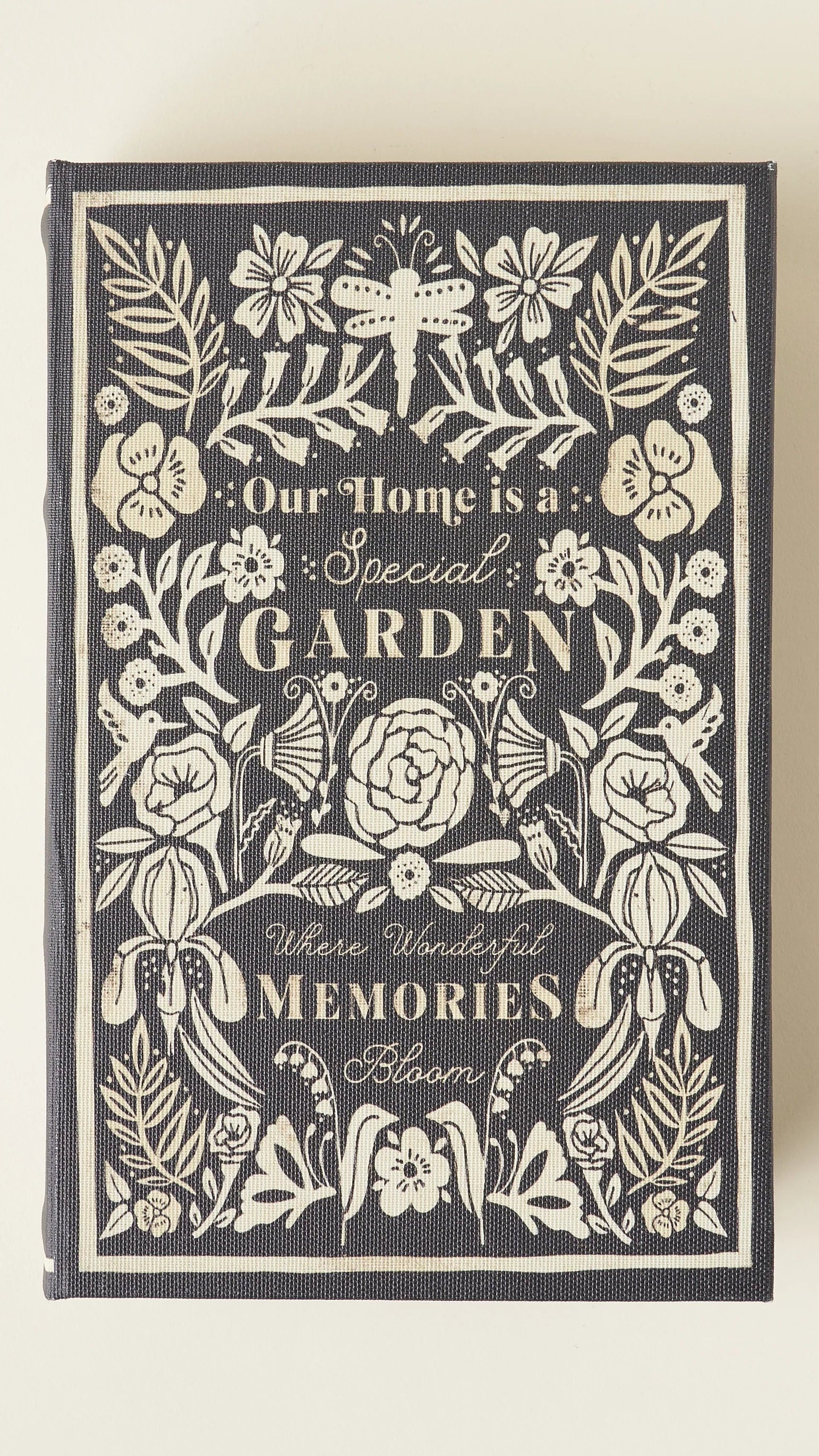 Decorative book with floral design and text on a beige background