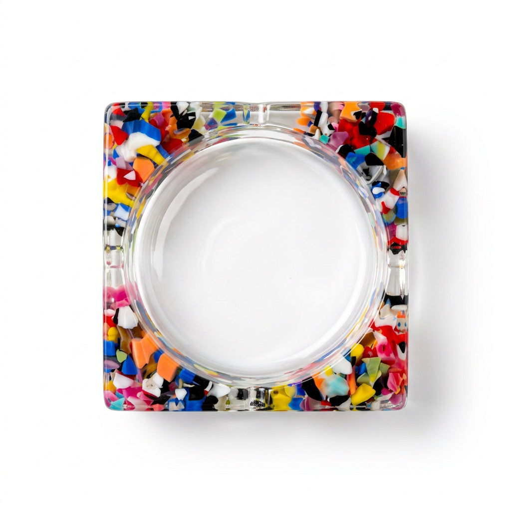 Square clear resin bangle bracelet with multicolor confetti pieces and round opening, top view.